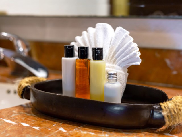 Bottles of toiletries on sink in bathroom of hotel room