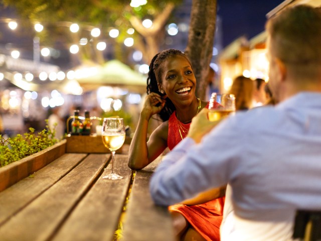 Two people drinking wine on patio