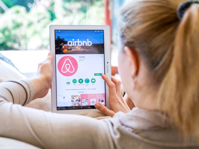 Traveler browsing Airbnb website on tablet