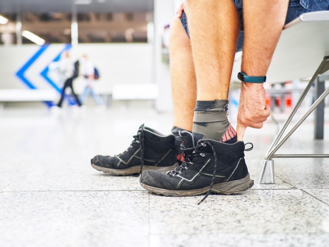 Traveler removing shoes at airport security