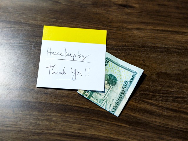 $20 tip with note for housekeeping on hotel room desk