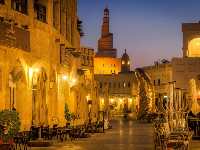 Outdoor tables along street in Doha, Qatar, at night