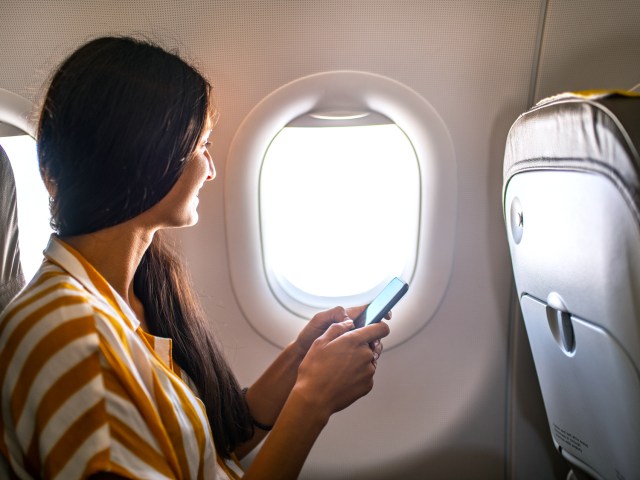 Airplane passenger looking out window