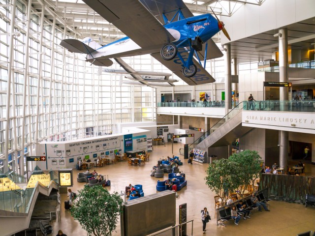 Vintage airplanes suspended from ceiling inside terminal at Seattle-Tacoma International Airport