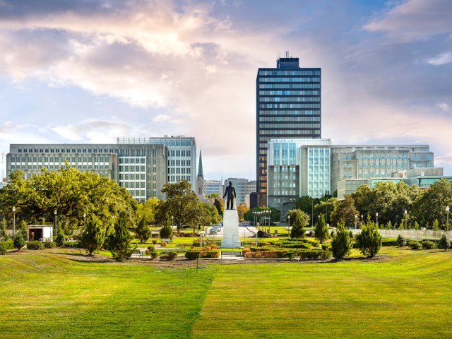 Statue in grassy park, with skyscrapers in background, in Baton Rouge, Louisiana