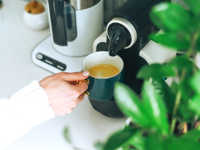 Close-up image of person using espresso machine