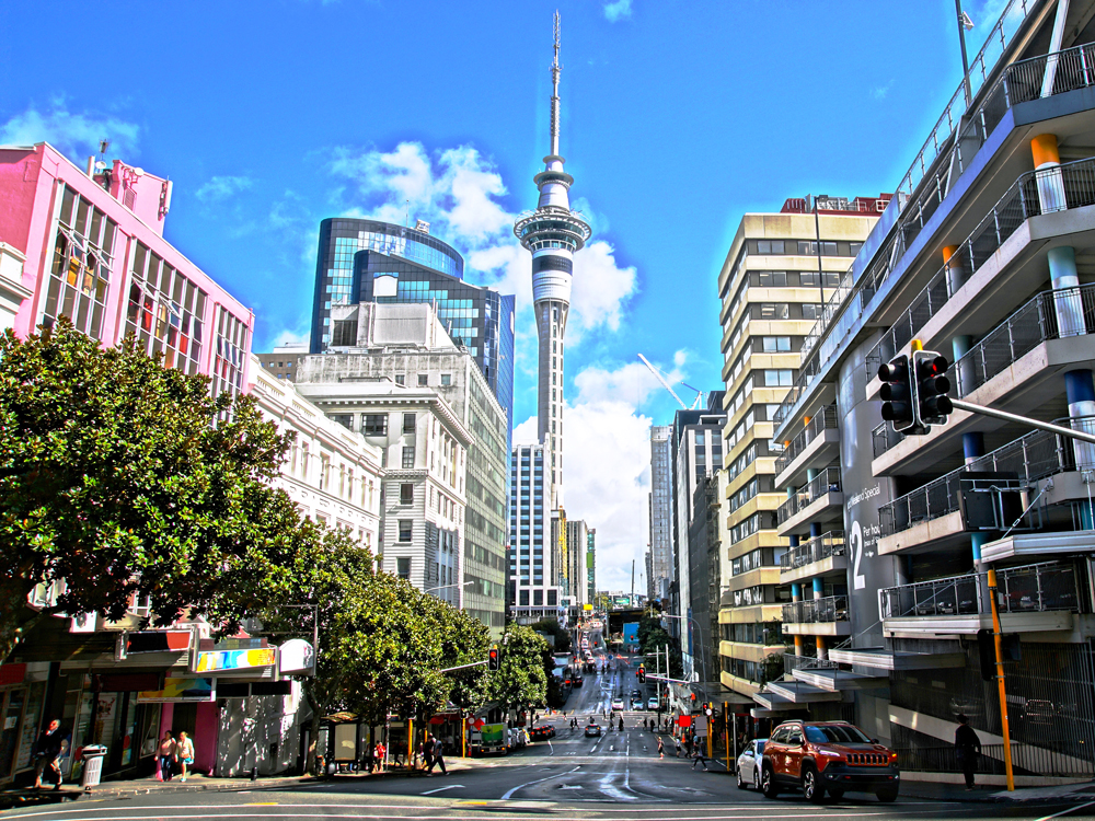 Busy street in Auckland, New Zealand, with view of the Sky Tower