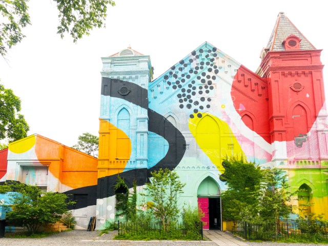 Exterior of Culture House in Washington, D.C. covered in bright mural