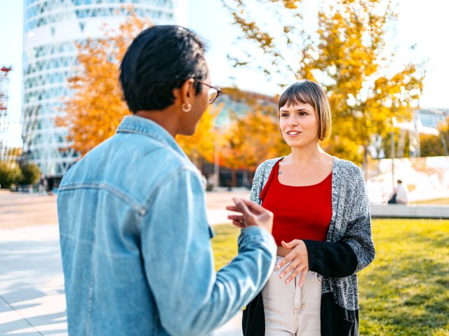 Two people conversing on street