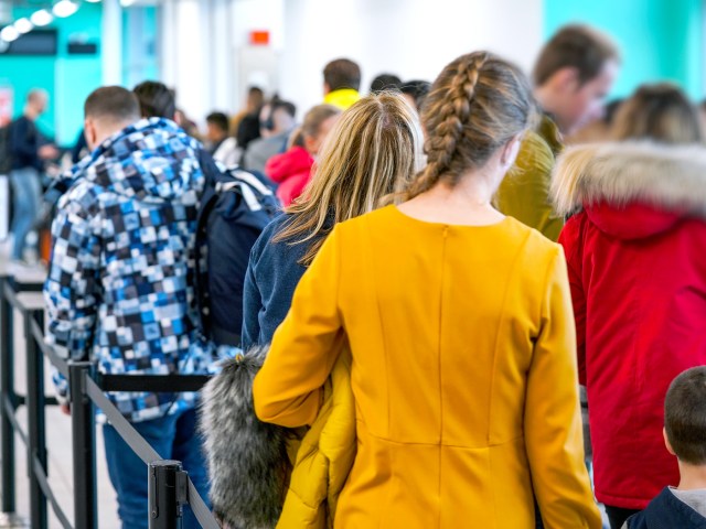 Travelers in airport security queue