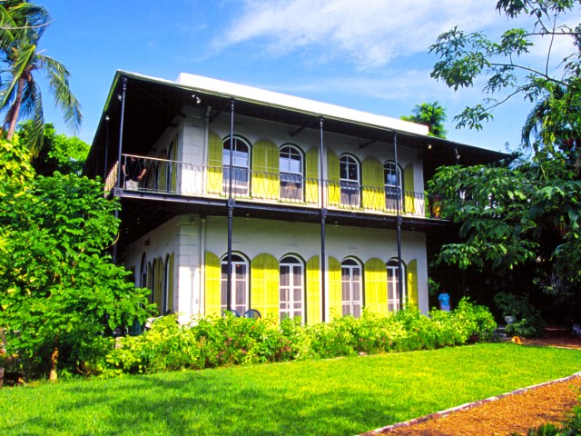 Brightly painted exterior of the Hemingway Home and Museum in Key West, Florida