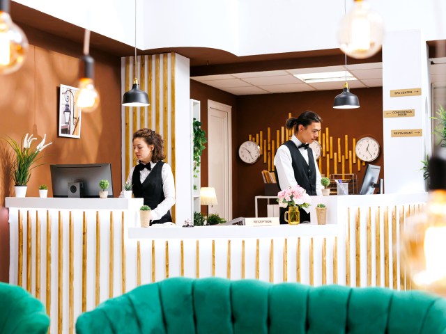 Staff working behind desk at hotel reception