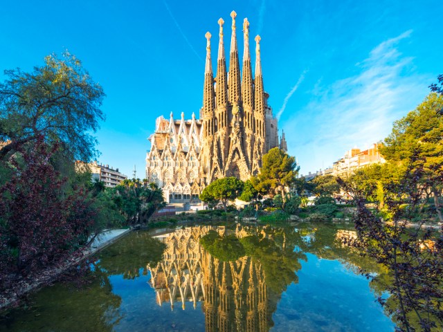 Basílica de la Sagrada Família in Barcelona, Spain, with reflection on pond