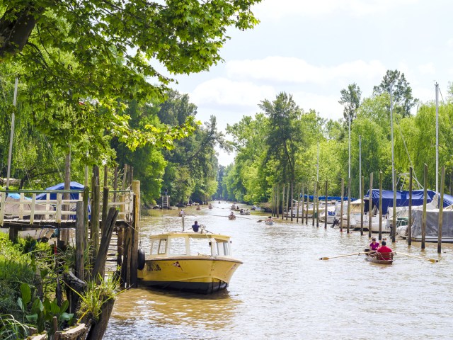 People rowing boats in canals of Tigre, Argentina