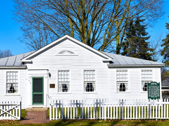 White picket fence in front of Dr. Nathan Thomas House in Schoolcraft, Michigan