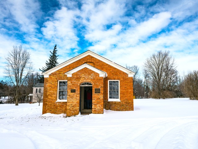 Brick home surrounded by snowy landscape at Gerrit Smith Estate National Historic Landmark in Peterboro, New York