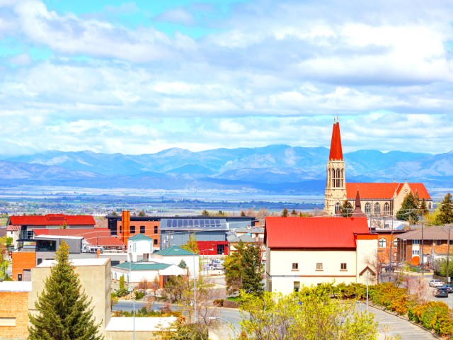 Red-roofed buildings of Helena, Montana, with mountains in distance