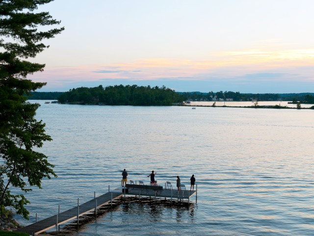 People standing on dock on lake near Leader, Minnesota