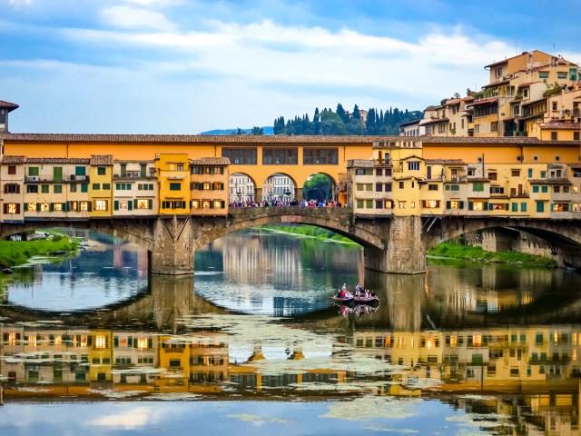 Ponte Vecchio bridge with reflection on river in Florence, Italy