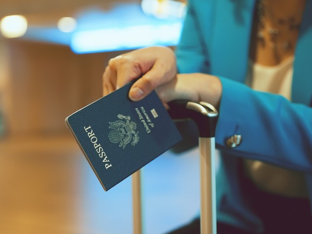 Close-up image of traveler holding passport