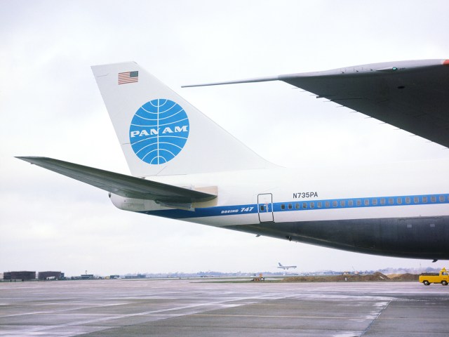 View of tail of Pan Am Boeing 747 parked at airport gate