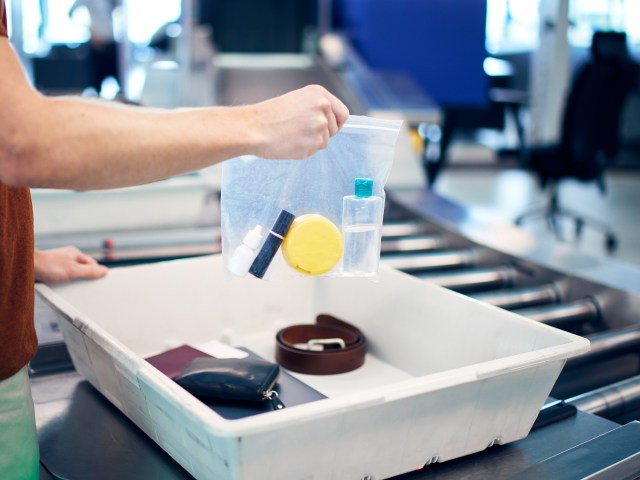 Traveler holding clear plastic bag of liquids at airport security