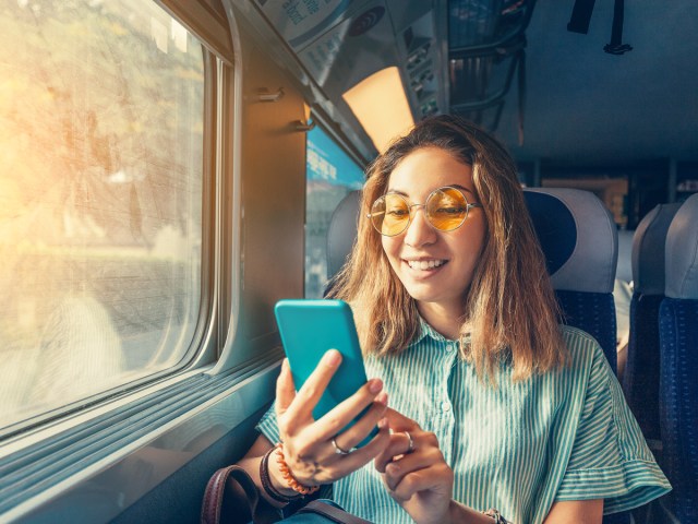 Train passenger using cellphone