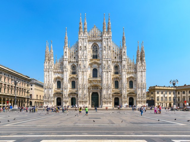 Tourists standing in front of Il Duomo cathedral in Milan, Italy