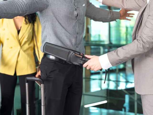 Security officer conducting passenger screening at airport