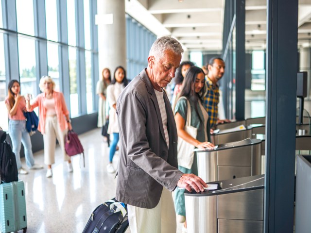 Traveler scanning boarding pass at airport gate