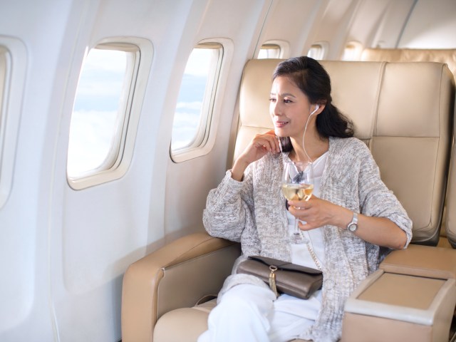 Traveler sitting in plush airplane seat