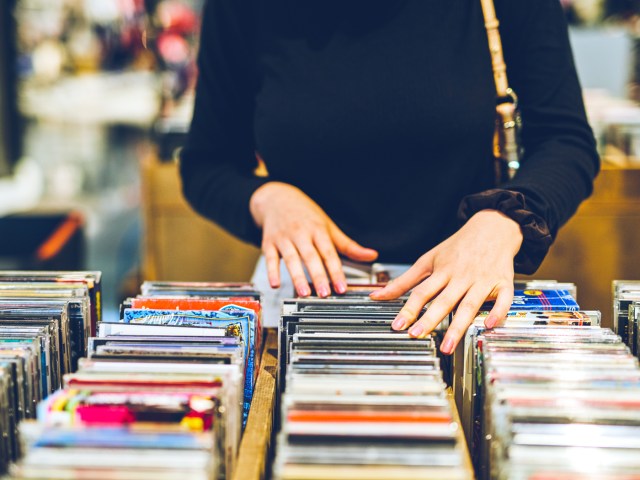 Person browsing CDs at store