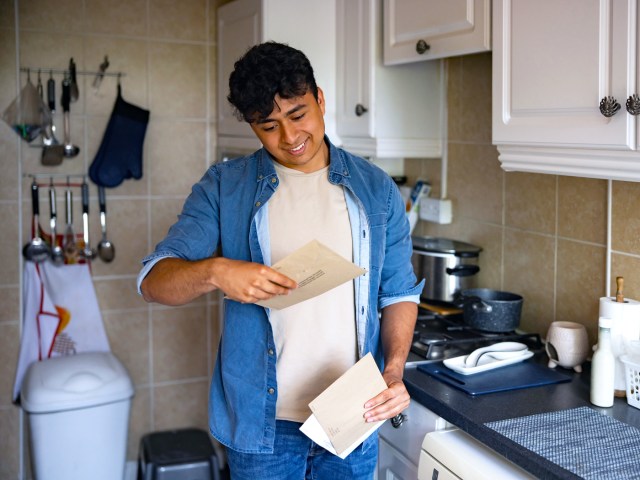 Man checking mail in kitchen