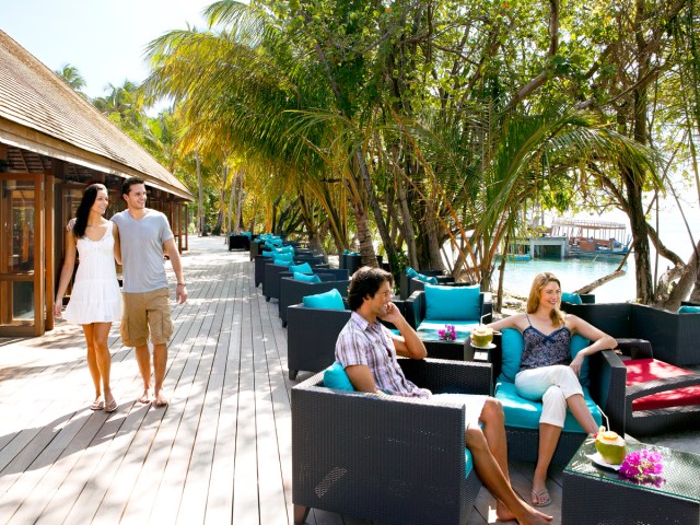 Hotel guests relaxing on outdoor furniture