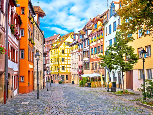 Cobblestone street lined with colorful buildings in Nuremberg, Germany