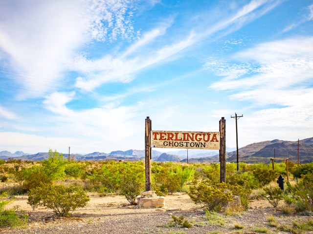 Sign for Terlingua Ghostown in desert landscape of West Texas