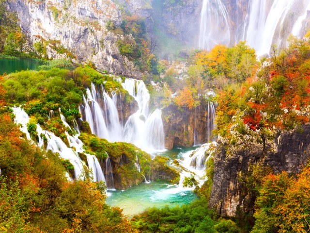 Fall foliage surrounding waterfalls in Plitvice Lakes, Croatia