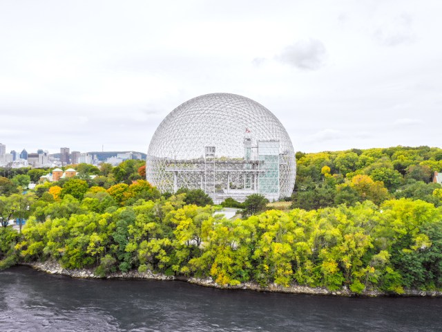 Montreal Biosphere surrounded by foliage, seen across St. Lawrence River