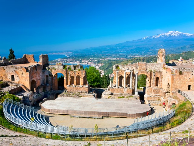 View of Mount Etna and Sicilian coast from the ancient Teatro Greco in Taormina