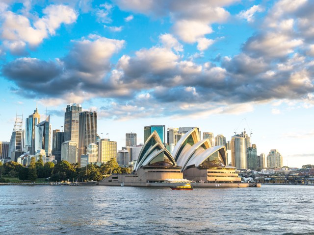 View across Sydney Harbour of Sydney skyline with iconic Sydney Opera House