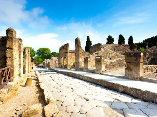 Stepping stones lined with ruins in Pompeii, Italy