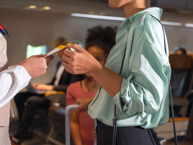 Airline staff checking passenger's boarding pass