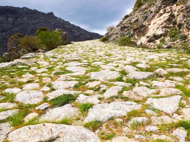 Stepping stones surrounded by mountains on the Puerto del Pico ancient Roman road in modern-day Spain