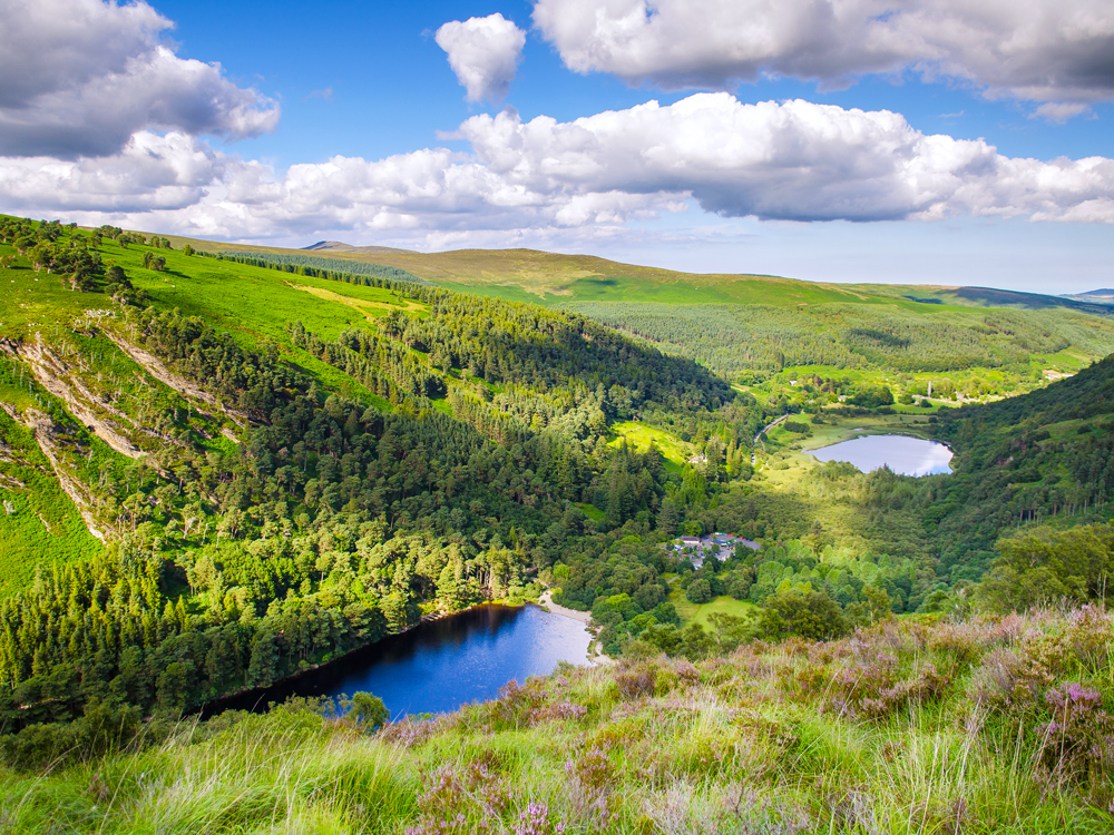 Lush green rolling hills and small lakes in Ireland