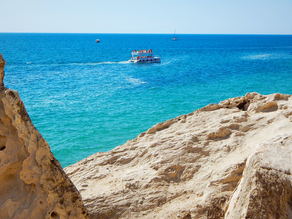 Boats off rocky shoreline of the Caspian Sea