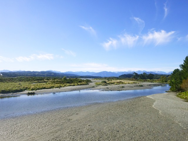 River flowing through landscape of Kakapotahi, New Zealand