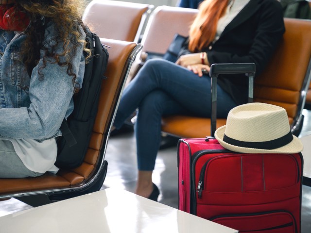 Passengers waiting at airport boarding gate