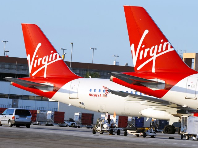 Two Virgin America planes at their gates 