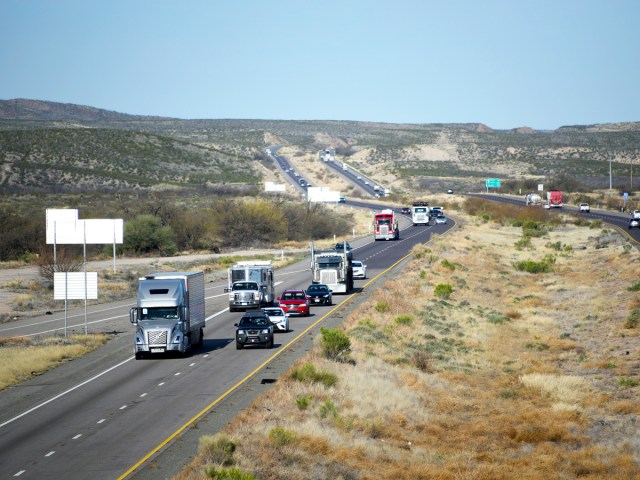 Commercial trucks and personal vehicles driving on I-10 in Phoenix, Arizona