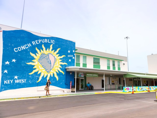 Traveler standing in front of mural outside Key West International Airport in Florida